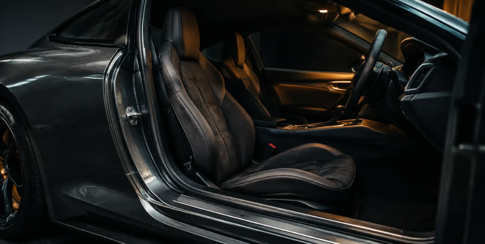 Open door of a sports car showing the seats
